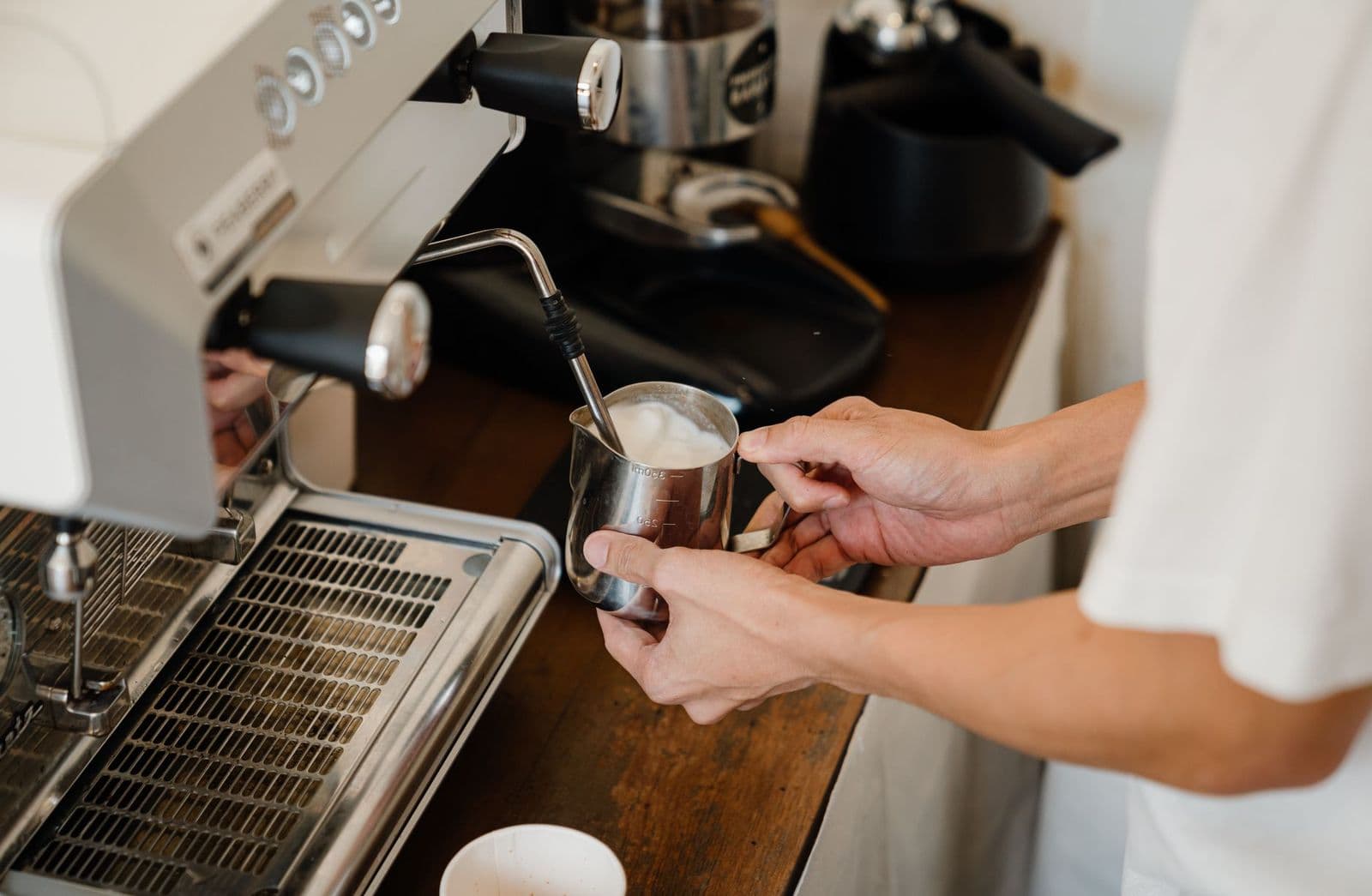 Milk being frothed for a cappuccino on an espresso machine